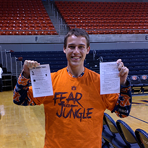 Me in my normal basketball game attire of an Auburn onesie and my Jungle shirt handing our copies of The Jungle Times.
